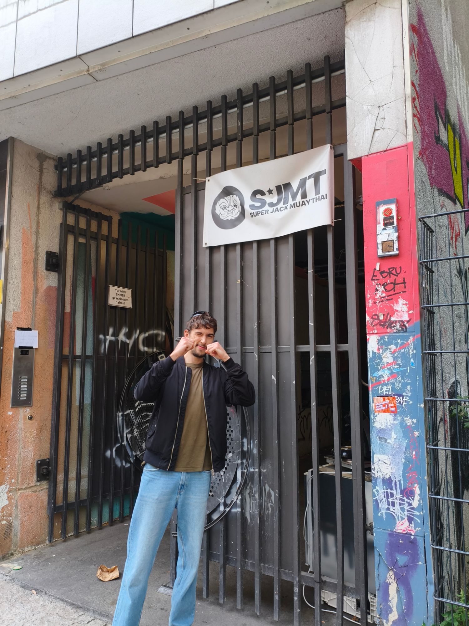Me in a fighting stance outside the Super Jack Muay Thai entrance in Berlin